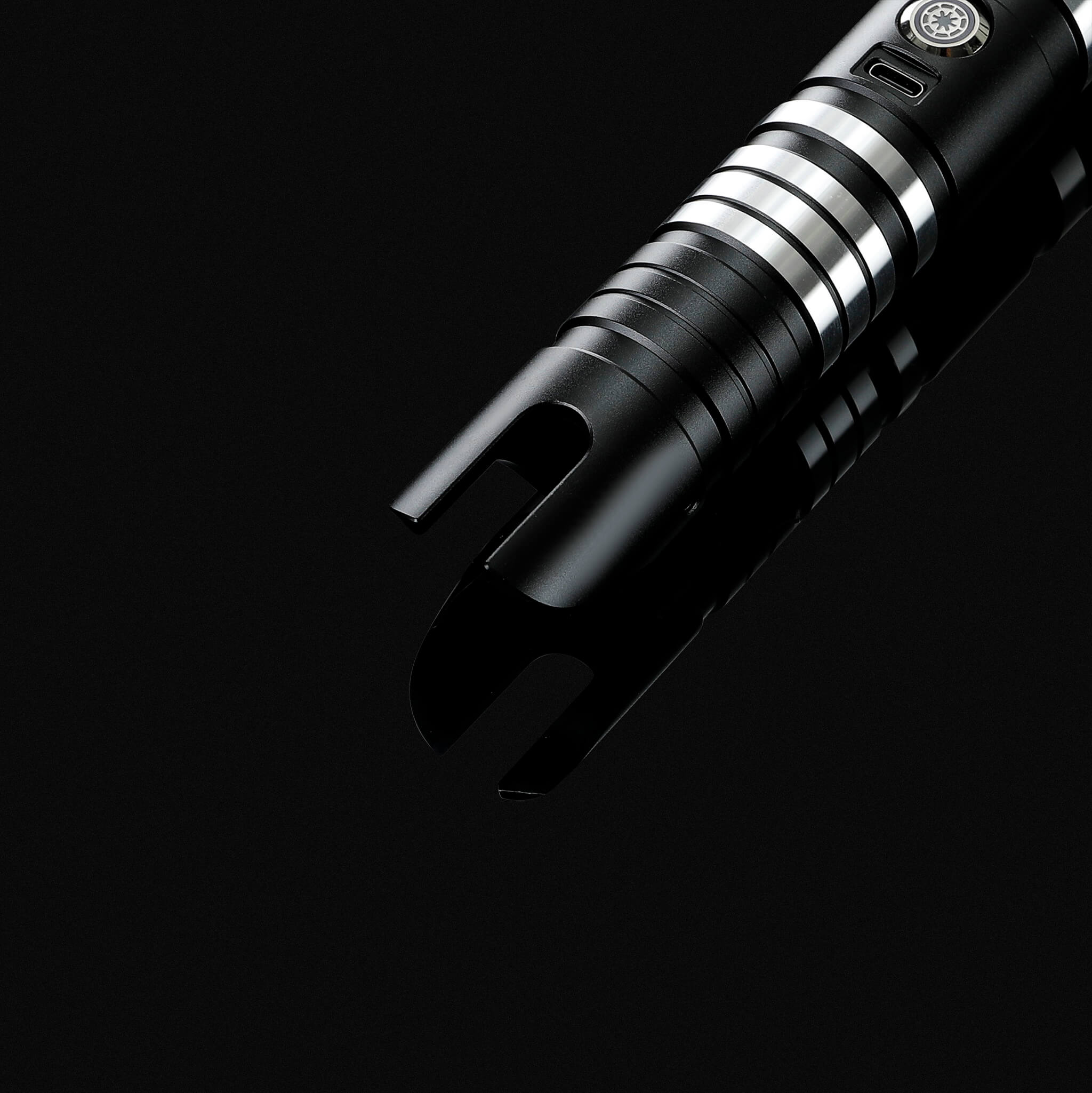 Tactical slanted emitter design on the black metal handle of an infinite color changing light saber.