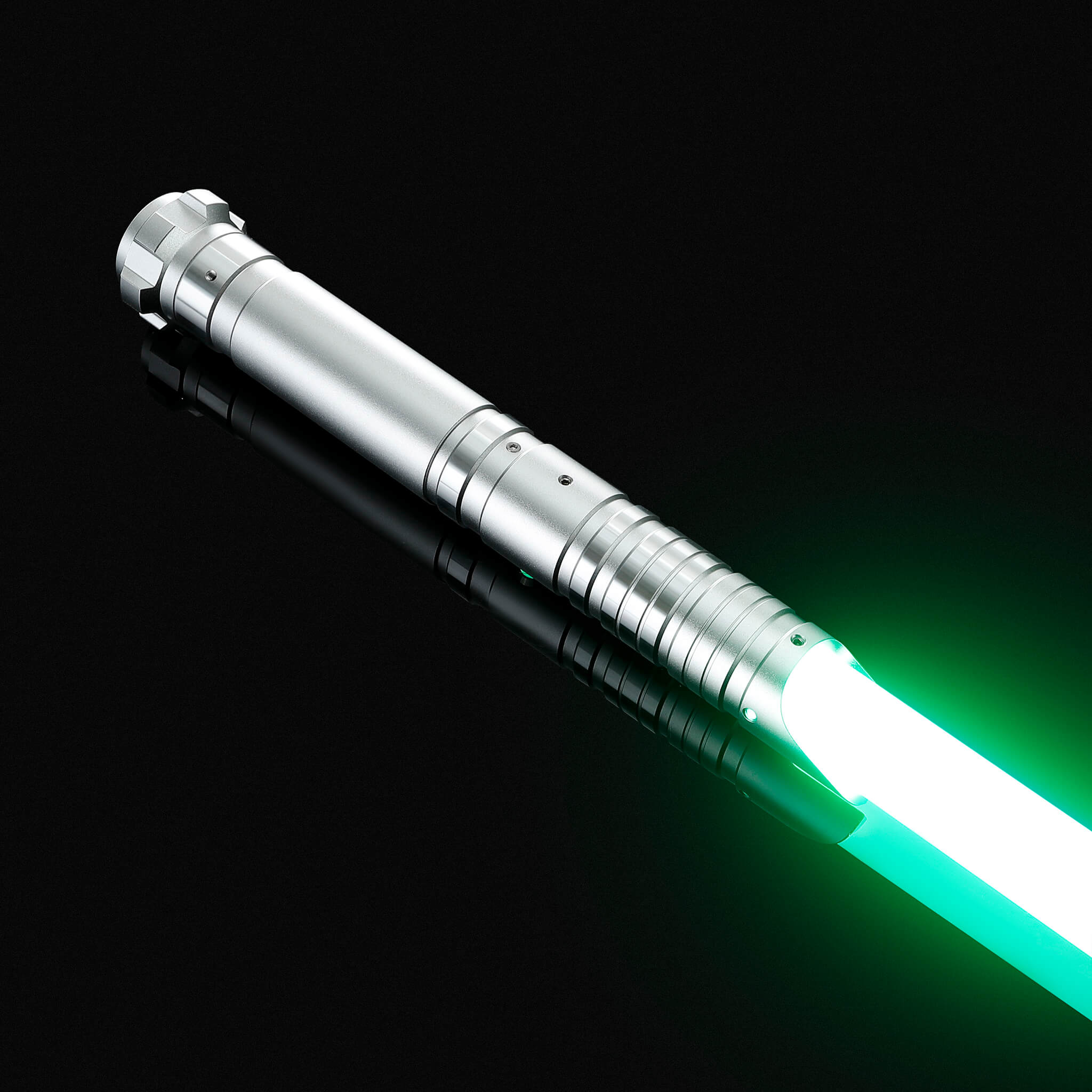 Side view of the titanium gray aluminum hilt light saber glowing with a green light.