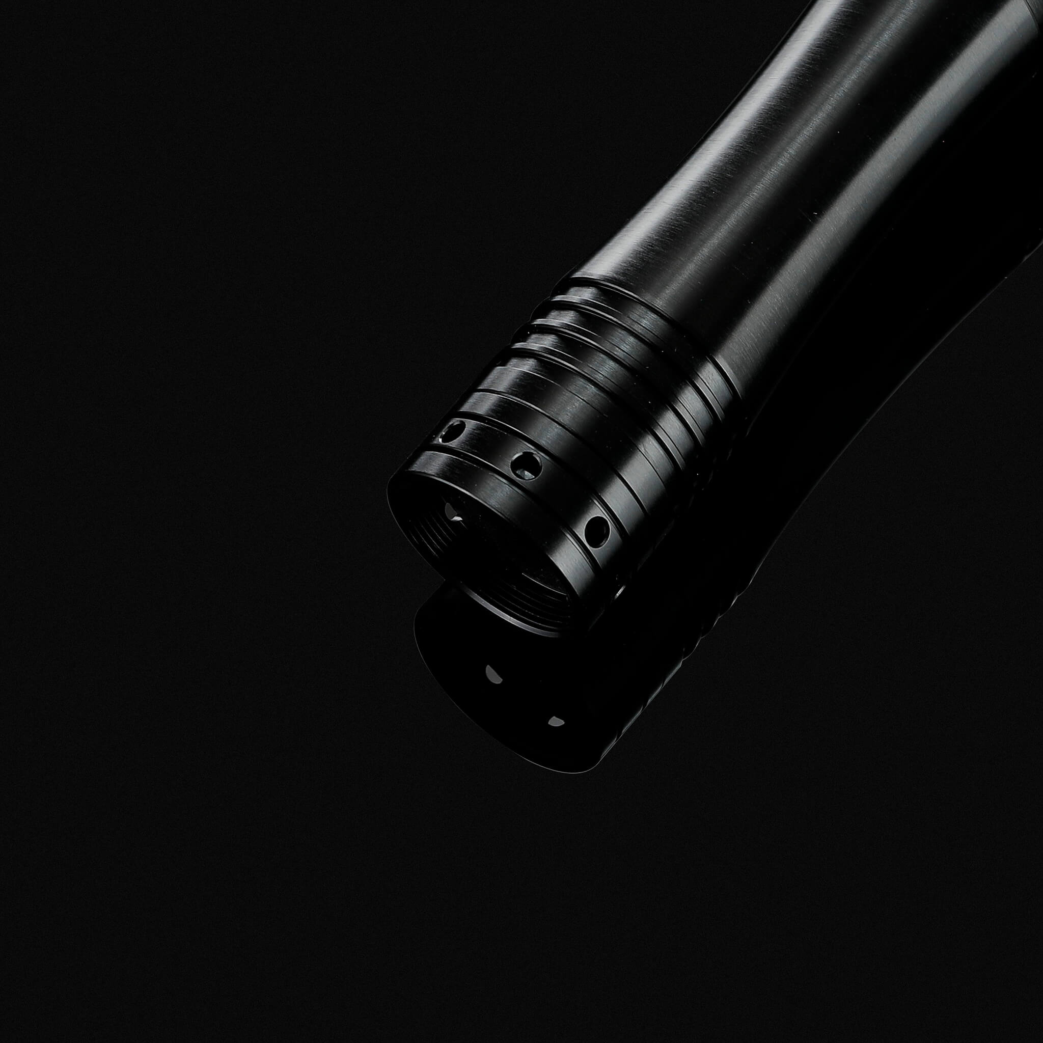 Bottom view of the black metal lightsaber handle showing the high quality speaker pommel