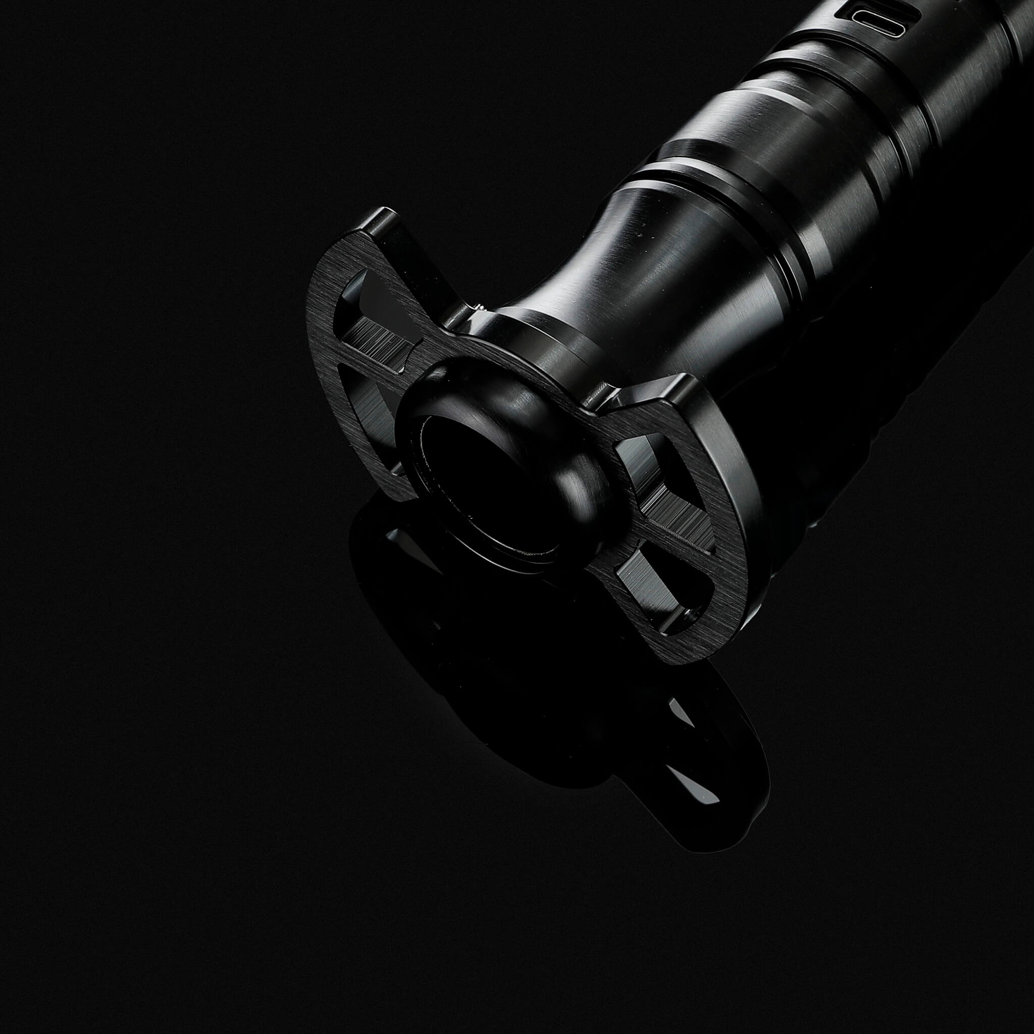 Close up view of the black metal lightsaber hilt focusing on the protective guard design