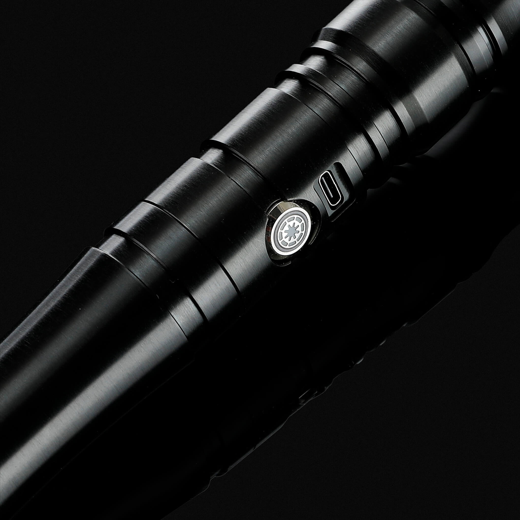 Macro shot of the black aluminum handle featuring the metal power switch button