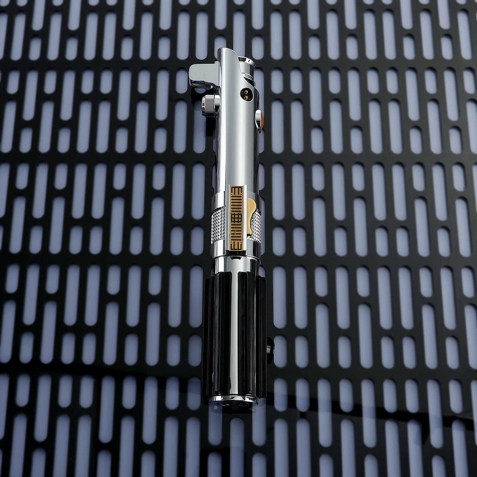 Close-up of Anakin Skywalker Episode 3 Lightsaberactivation panel: tactile switches and jedi council-approved hilt geometry