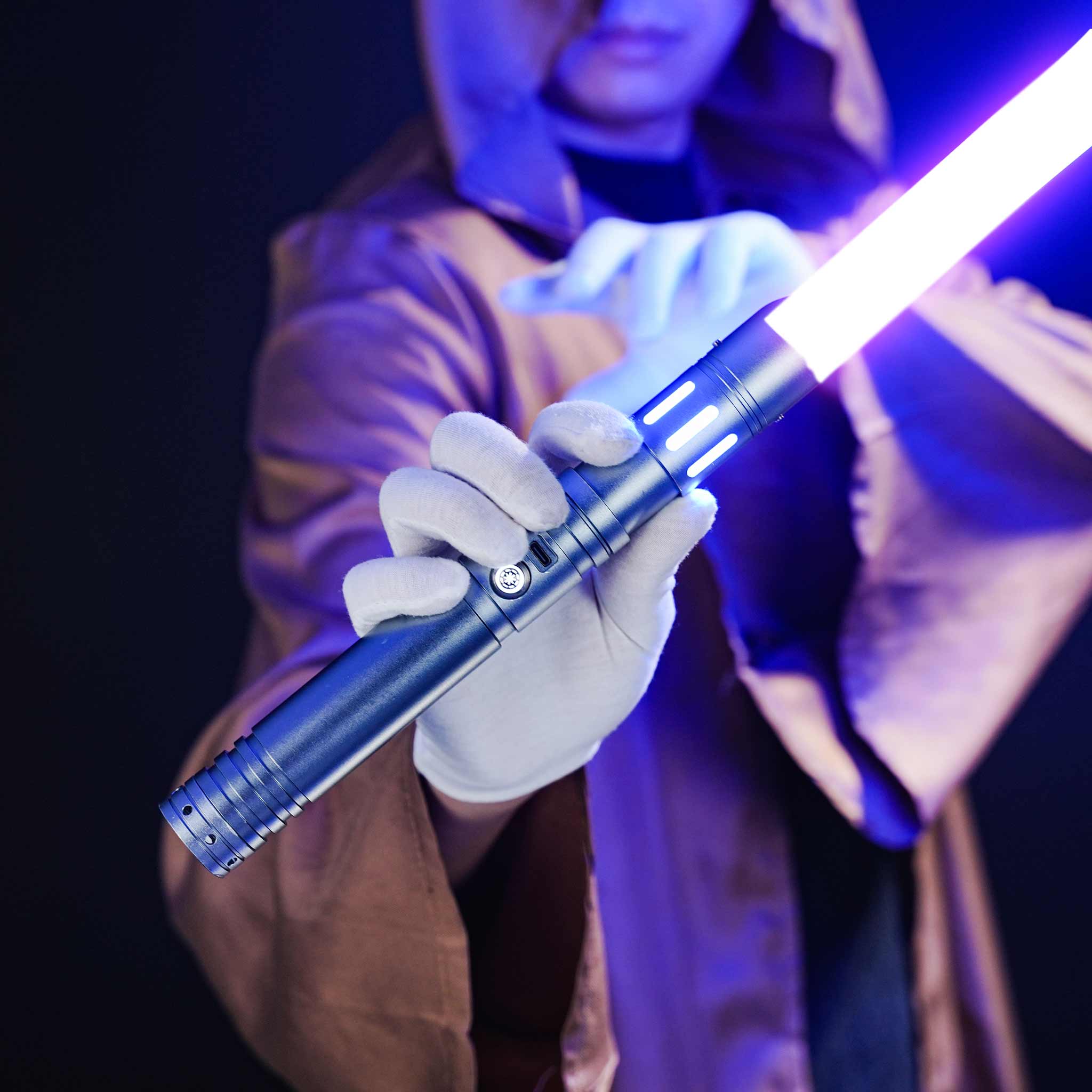 Cosplayer wearing a robe holding the FX combat light saber with heavy dueling RGB pixel setup