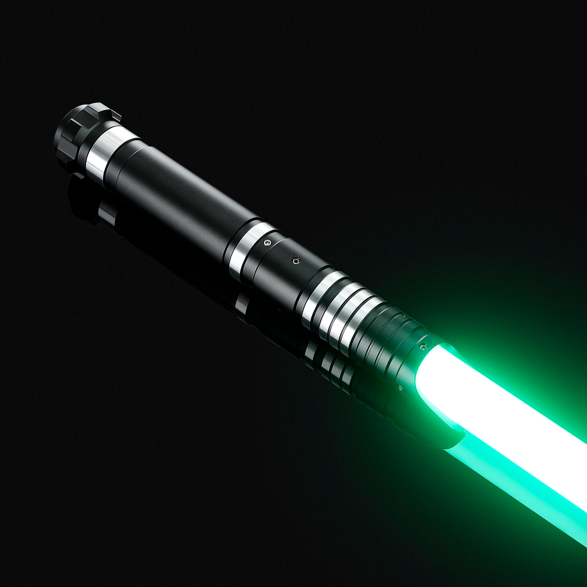 Side view of the black hilt infinite color changing light saber glowing with a bright green light.