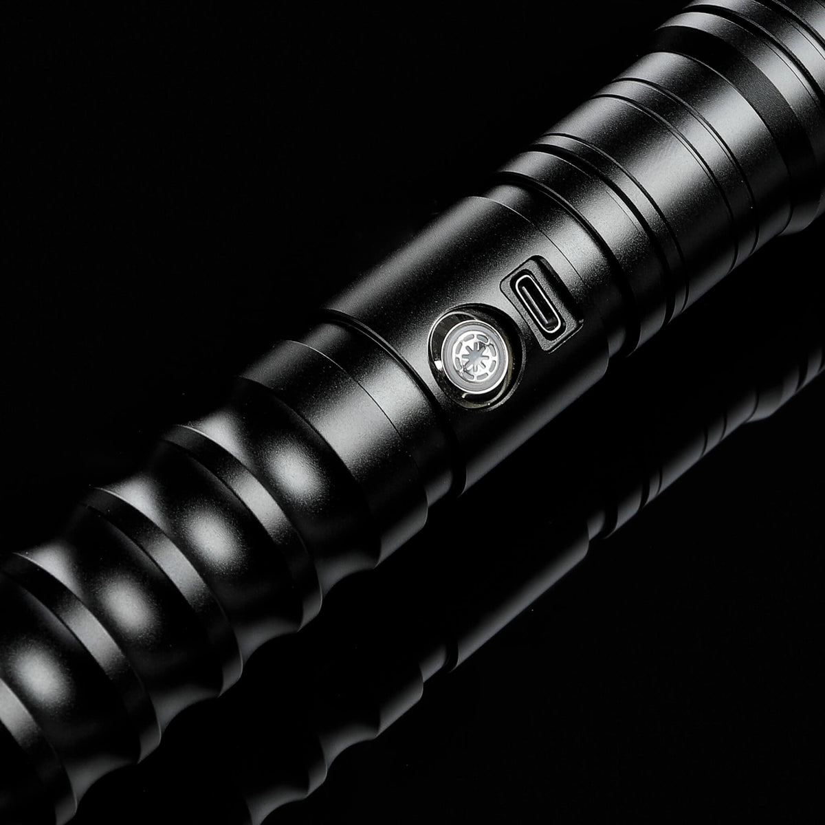 Power button and USB-C charging port on black metal lightsaber hilt