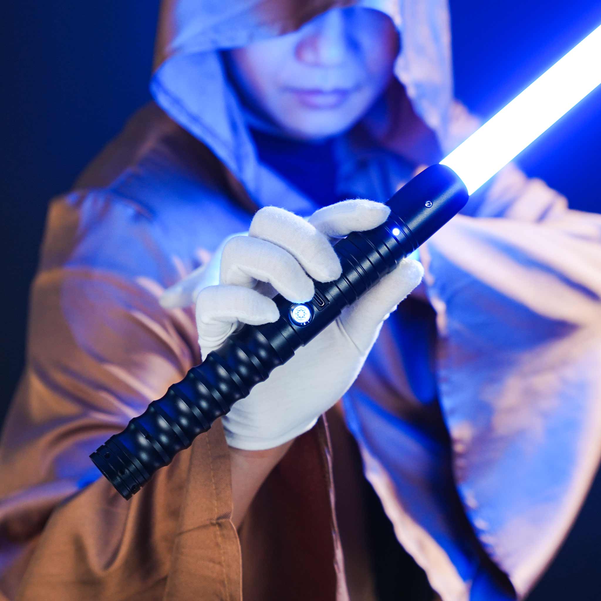 Person holding blue metal hilt lightsaber for cosplay and dueling