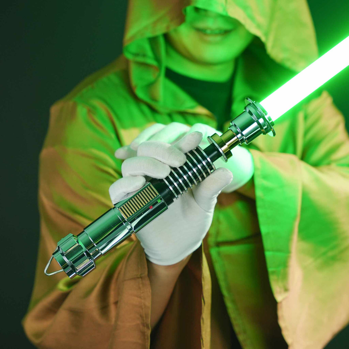 Person in hooded Jedi robe holding Luke Skywalker EP6 Hero Metal Lightsaber