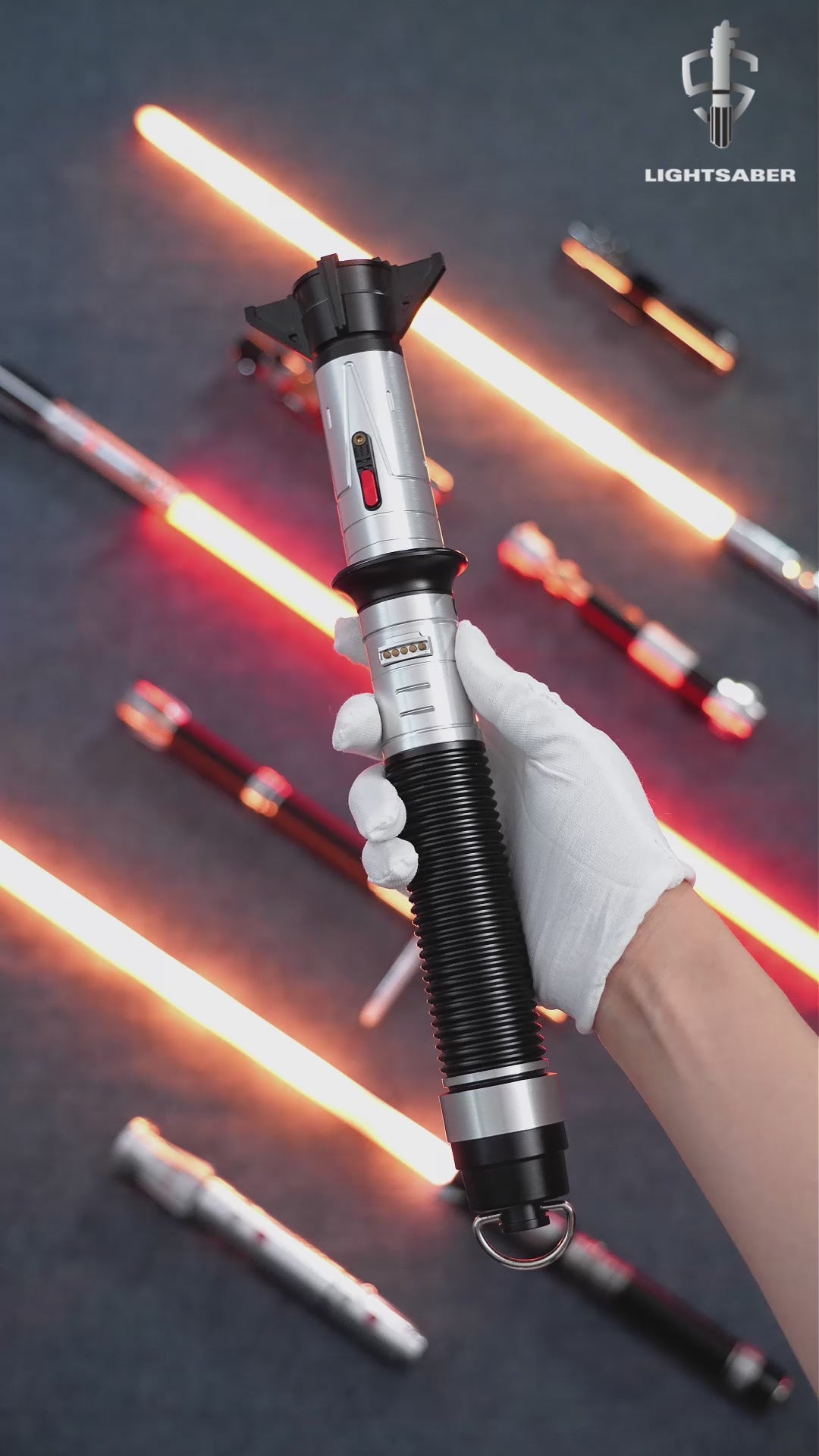 A product demonstration video of the LIGHTSABER® Baylan Skoll Saber, showcasing its unique weathered hilt design, bright orange-red NeoPixel blade, and smooth swing sound effects.